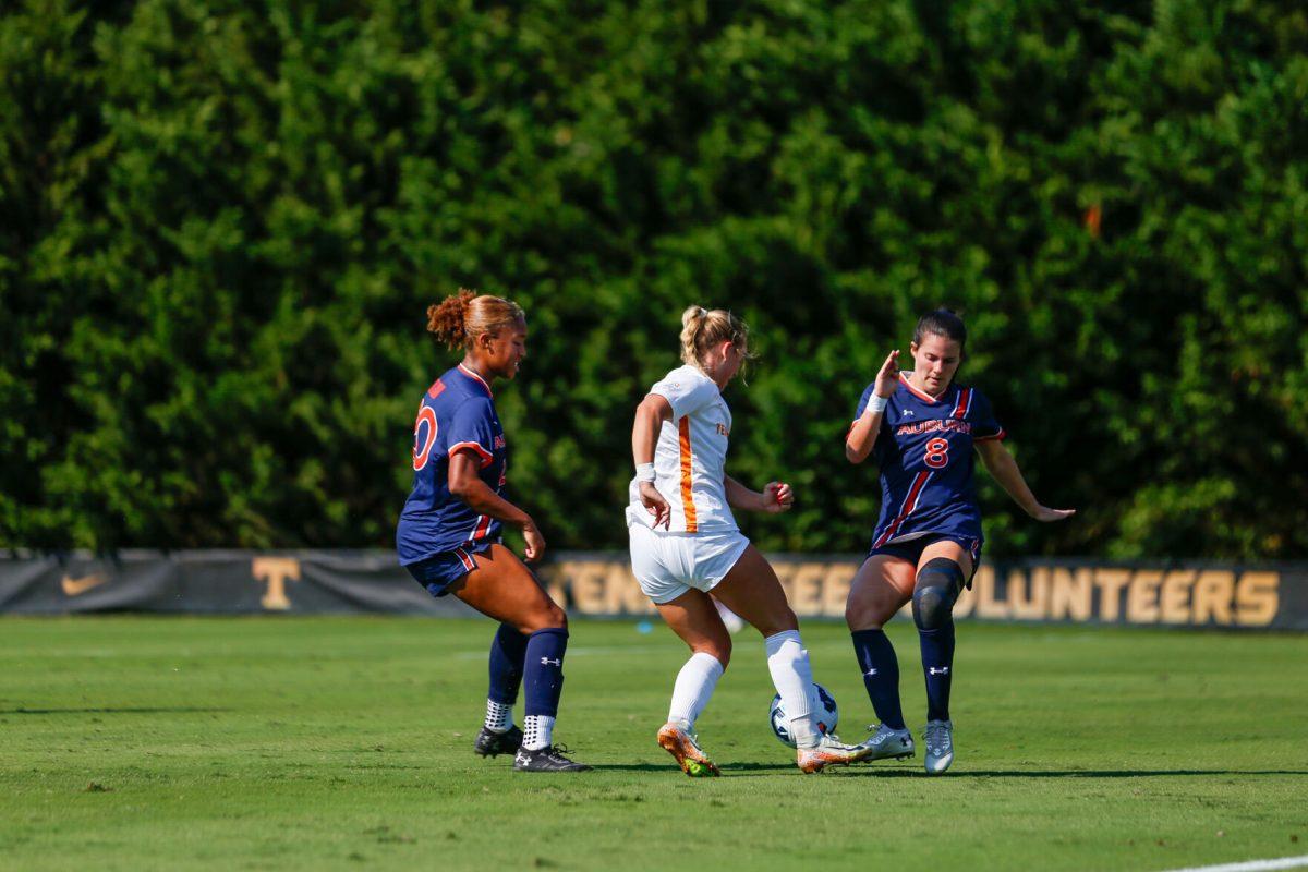 Jenna Stayart (5) dribbles between two Auburn defenders at Regal Soccer Stadium. Sunday, Oct. 13, 2024.