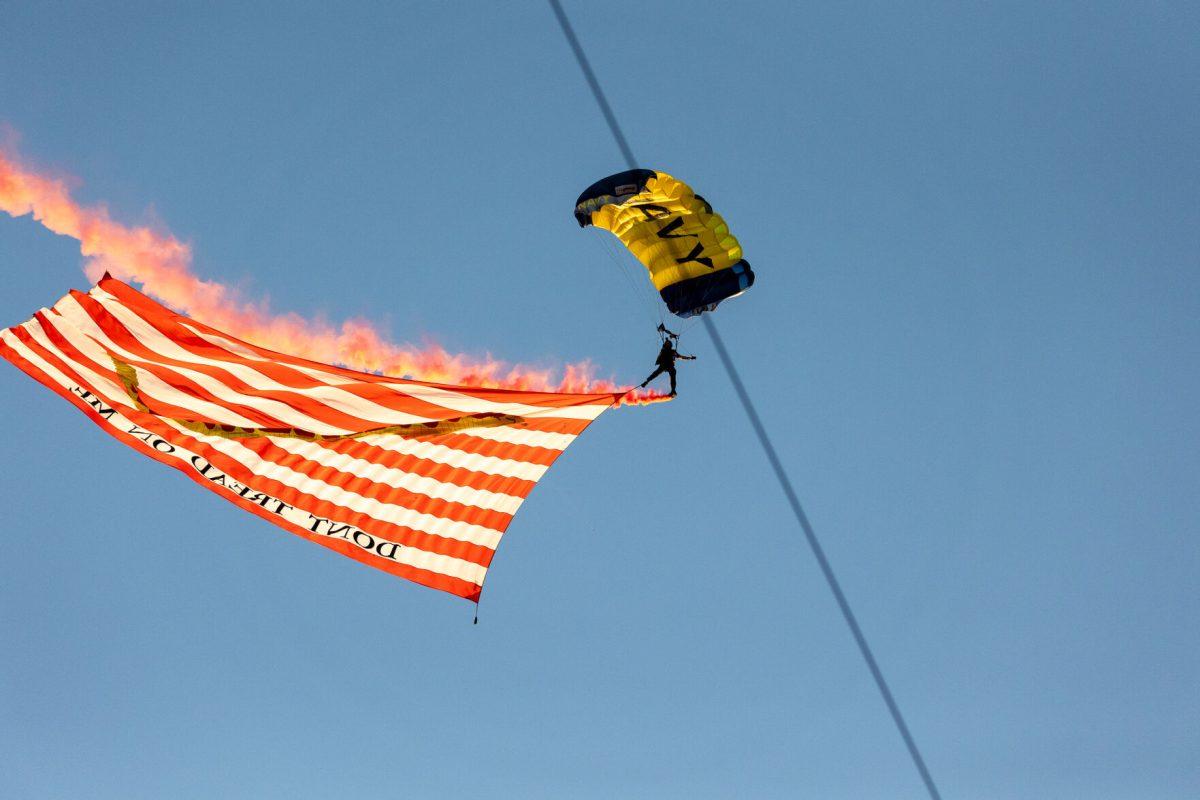 A member of the U.S. Navy flies into Donald W. Reynolds Razorback Stadium. Saturday, Oct. 5, 2024. 