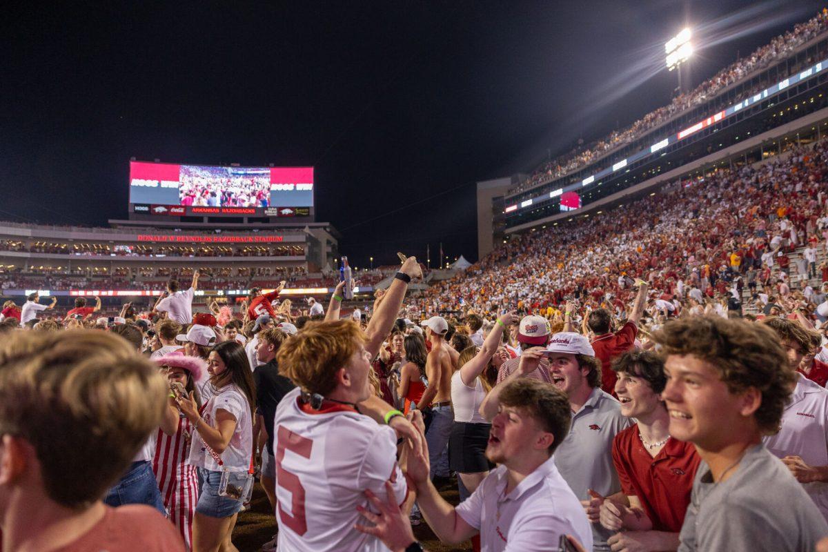 Arkansas fans storm the field after defeating Tennessee at Donald W. Reynolds Razorback Stadium. Saturday, Oct. 5, 2024. 