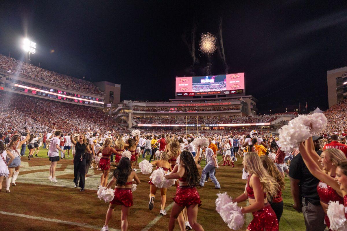 Arkansas fans storm the field after defeating Tennessee at Donald W. Reynolds Razorback Stadium. Saturday, Oct. 5, 2024. 