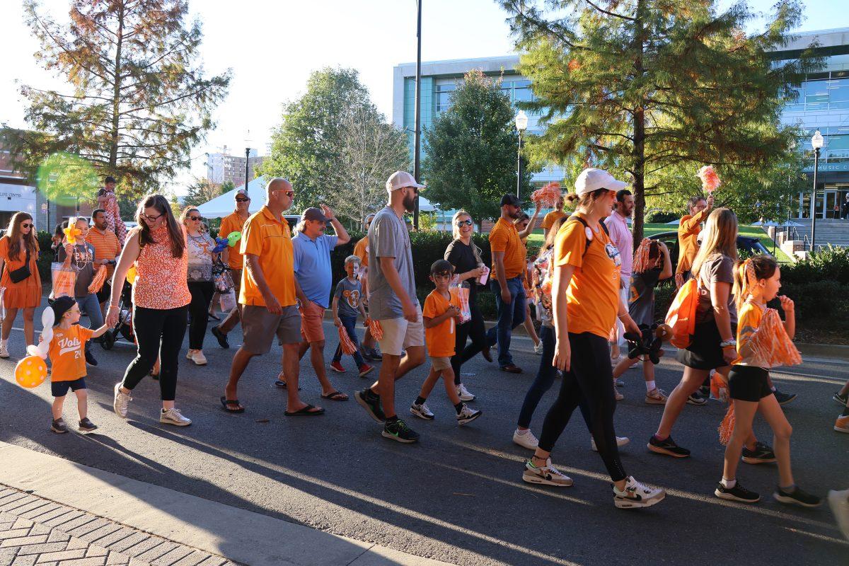Alumni and their kids participate in the Little Vol Walk in the homecoming parade. Friday, Nov. 8, 2024.