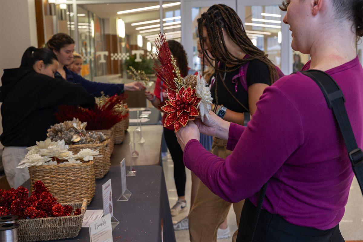 Students at the Let Love Bloom event create small flower bouquets inside the Student Union. Wednesday, Nov. 6, 2024.