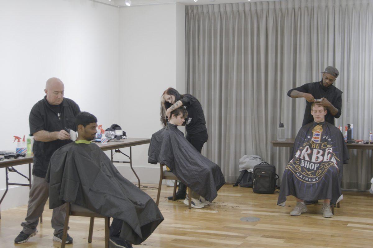 Barber students from the Master Academy of Barbering offer free haircuts for UT students in the Student Union Art Gallery. Wednesday, Nov. 13, 2024.