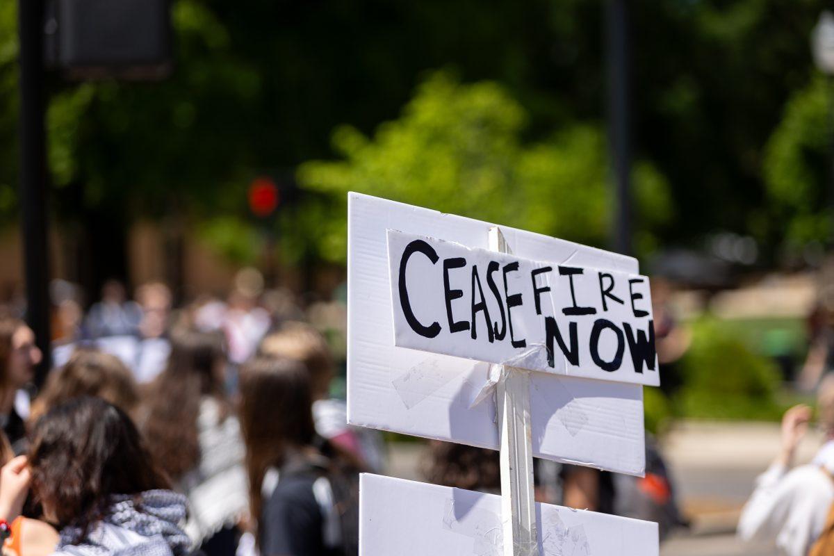 Students and community members gather in protest outside the College of Law. Wednesday, May 1, 2024.