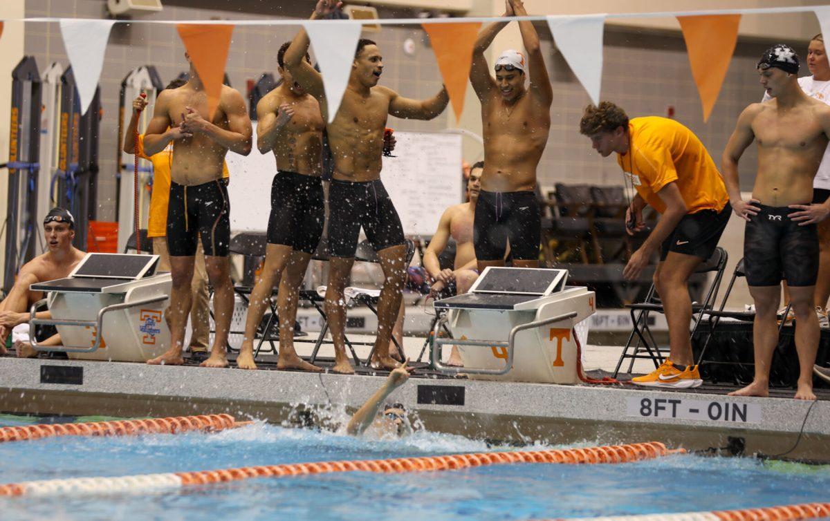 Jordan Crooks, Gui Caribe, Joaquin Vargas, and Björn Kammann celebrate their win in the Men's 800 Yard Freestyle Relay at Allan Jones Aquatic Center. November 19, 2024.