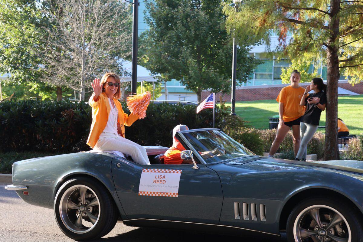 Alumni Board of Directors Presidet Lisa Reed waves to the crowd at the homecoming parade. Friday, Nov. 8, 2024.