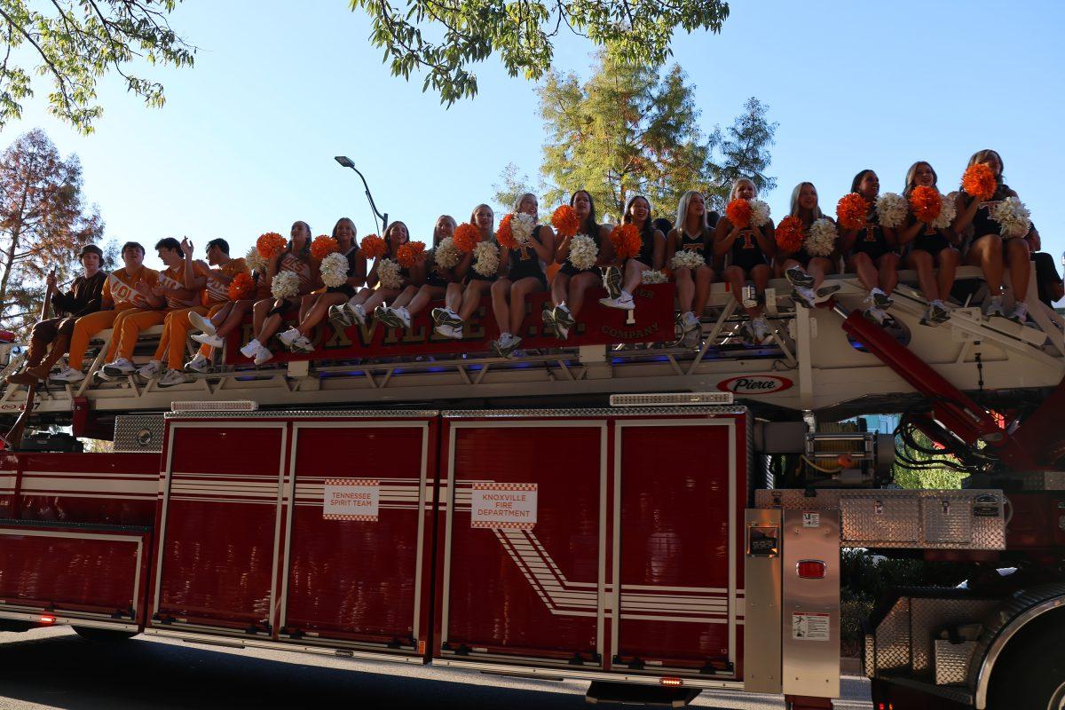 Members of the Spirit Squad ride on a fire truck during the 2024 Homecoming Parade. Friday, Nov. 8, 2024.