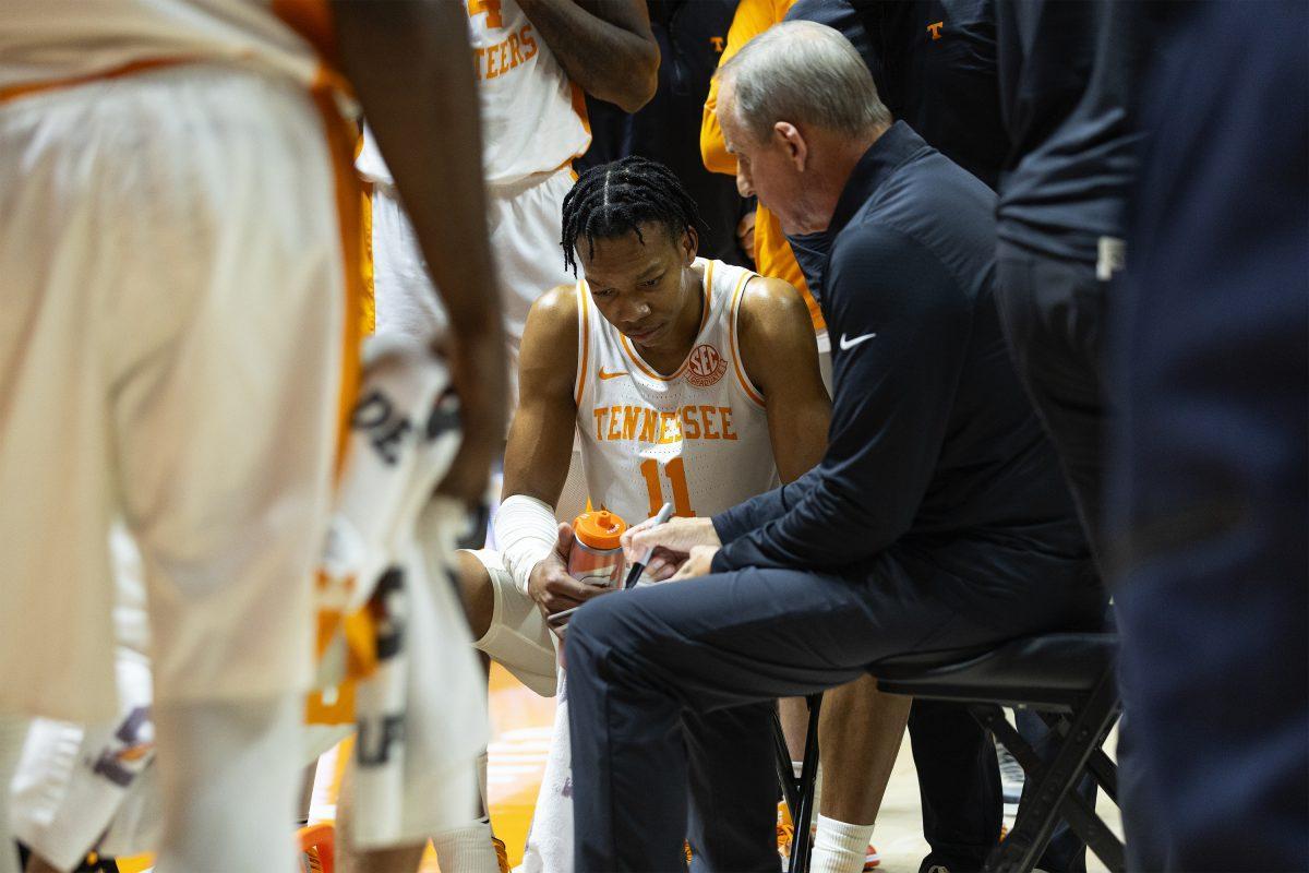 Jordan Gainey (11) looks on as Coach Rick Barnes draws up a play during a timeout against Norfolk St. at Thompson-Boling Arena at Food City Center. Tuesday, Dec. 31, 2024.