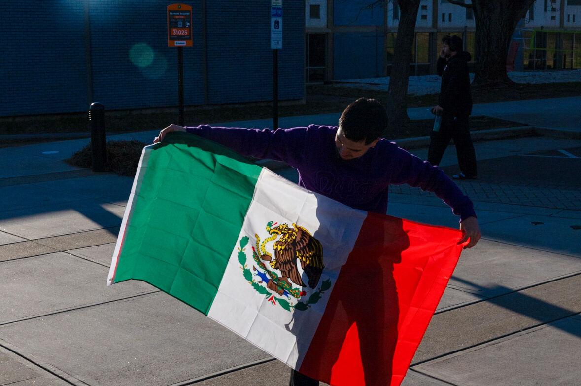 Eli Aguilar holding a Mexican flag to show his support for his family and all those under the threat of deportation right now. Monday, Feb. 17, 2025. 