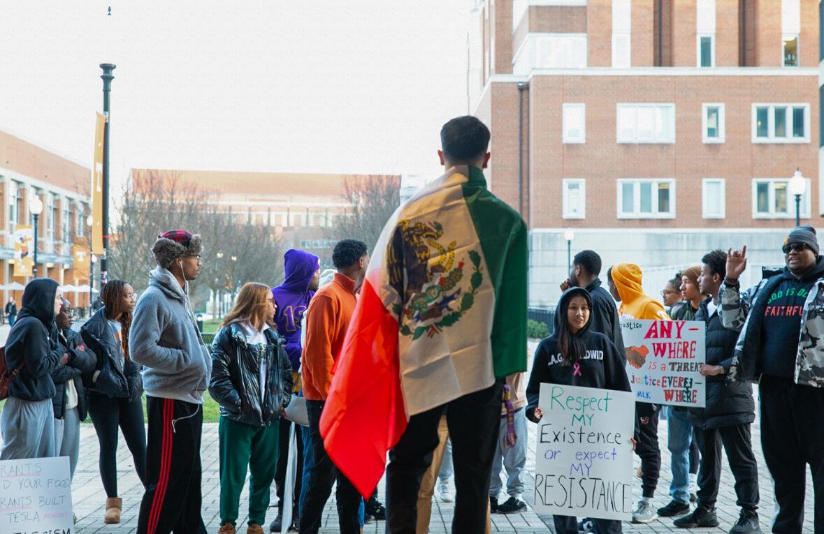 Eli Aguilar standing on a stage before his fellow protestors against fascism. Monday, Feb. 17, 2025. 