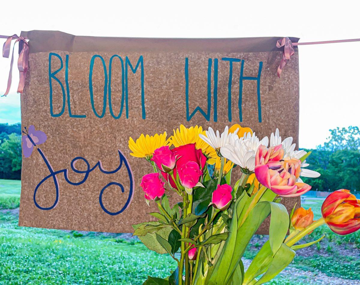 A bouquet of flowers in front of a handmade sign that reads, "bloom with joy." This is a nice reminder that despite your circumstances you can still bloom with joy, finding happiness in all kinds of love, whether its from friends, family or a significant other.