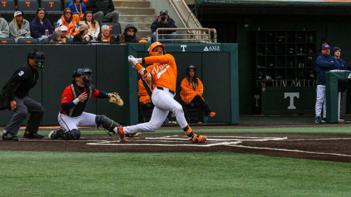 Andrew Fischer (11) swings and hits after a solid pitch against Samford at Lindsey Nelson Stadium. Saturday, Feb. 22, 2025.