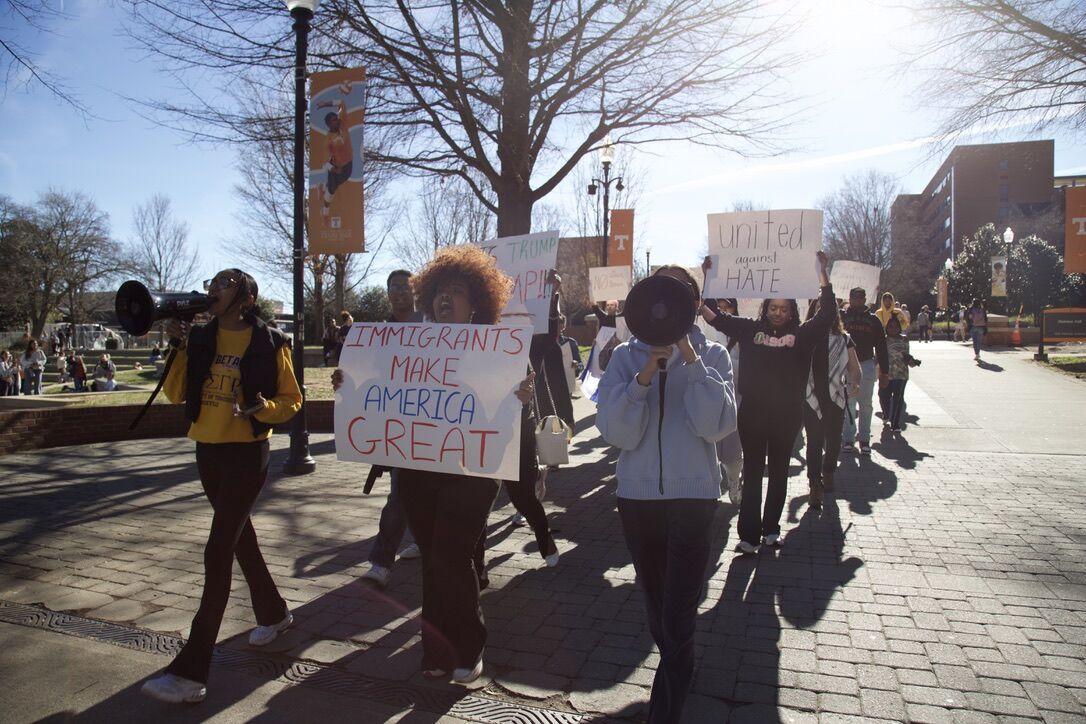 Students march down Pedestrian Walkway protesting against the Trump administration's recent policy changes affecting DEI Initiatives, immigrants and the environment. Friday, Feb. 28, 2025.