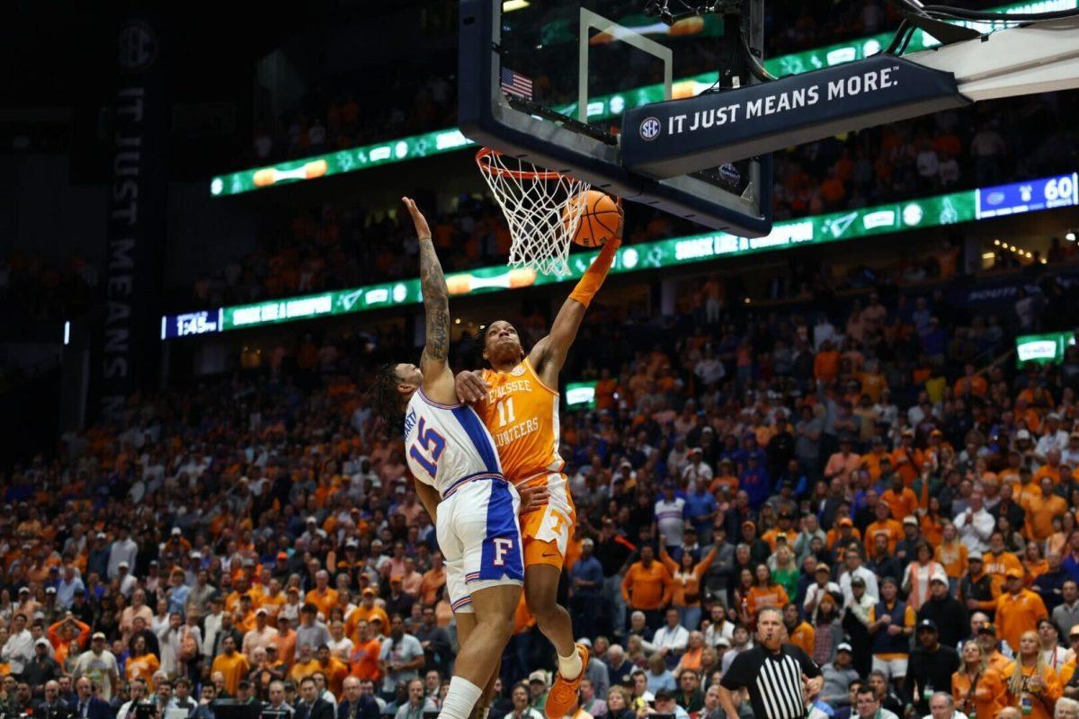 Jordan Gainey (11) attempts to dunk on Florida's Will Richard (15) during the SEC Championship game at Bridgestone Arena in Nashville, Tennessee. Sunday, March 16, 2025.