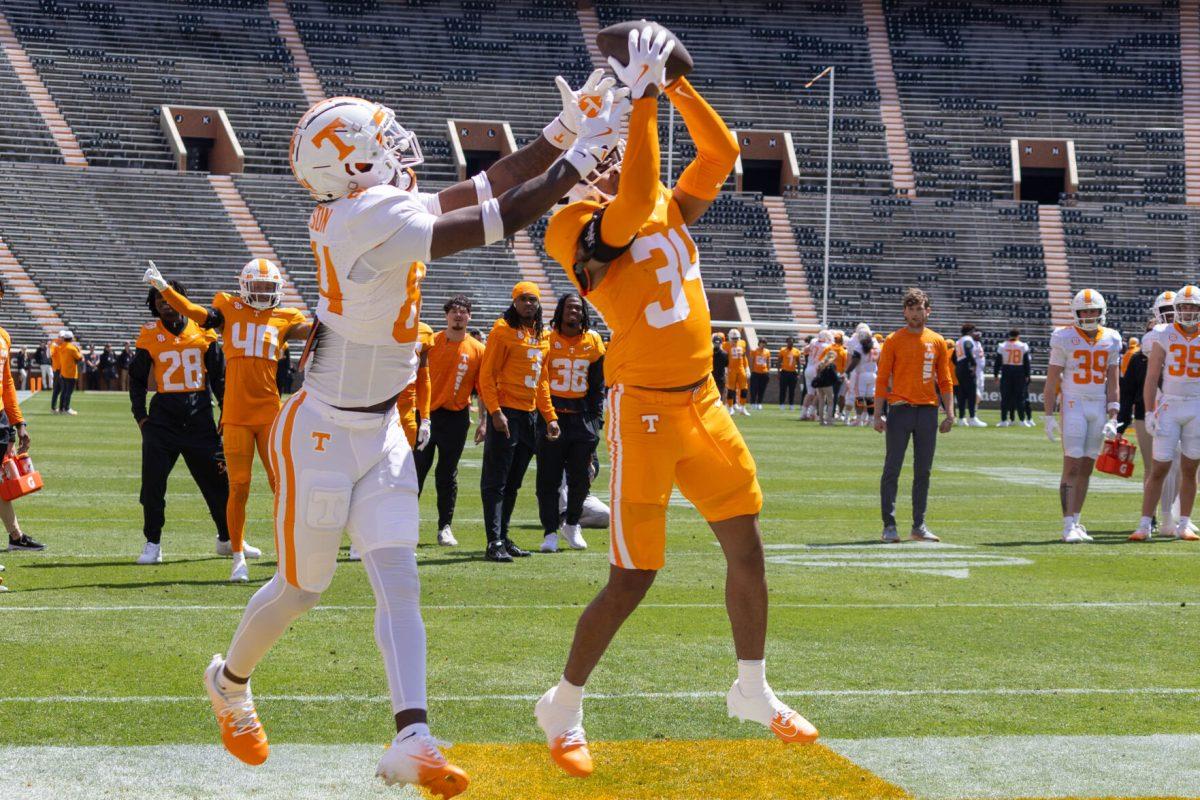 Radarious Jackson (84) and Dylan Lewis (34) battle for the ball during the Orange and White Game at Leyland Stadium. Saturday, April 12, 2025.