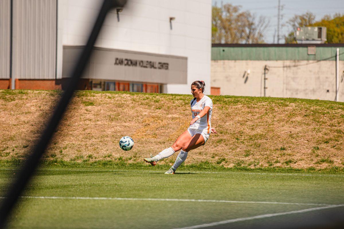 Bella Smith (4) kicks a free kick from the corner during a spring matchup against Virginia Tech at Regal Stadium. Sunday, April 13, 2025.