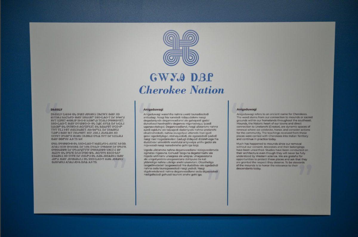 A didactic panel with a statement from the Cherokee Nation. From left to right: untranslated symbols, the untranslated letters, then translated into English.