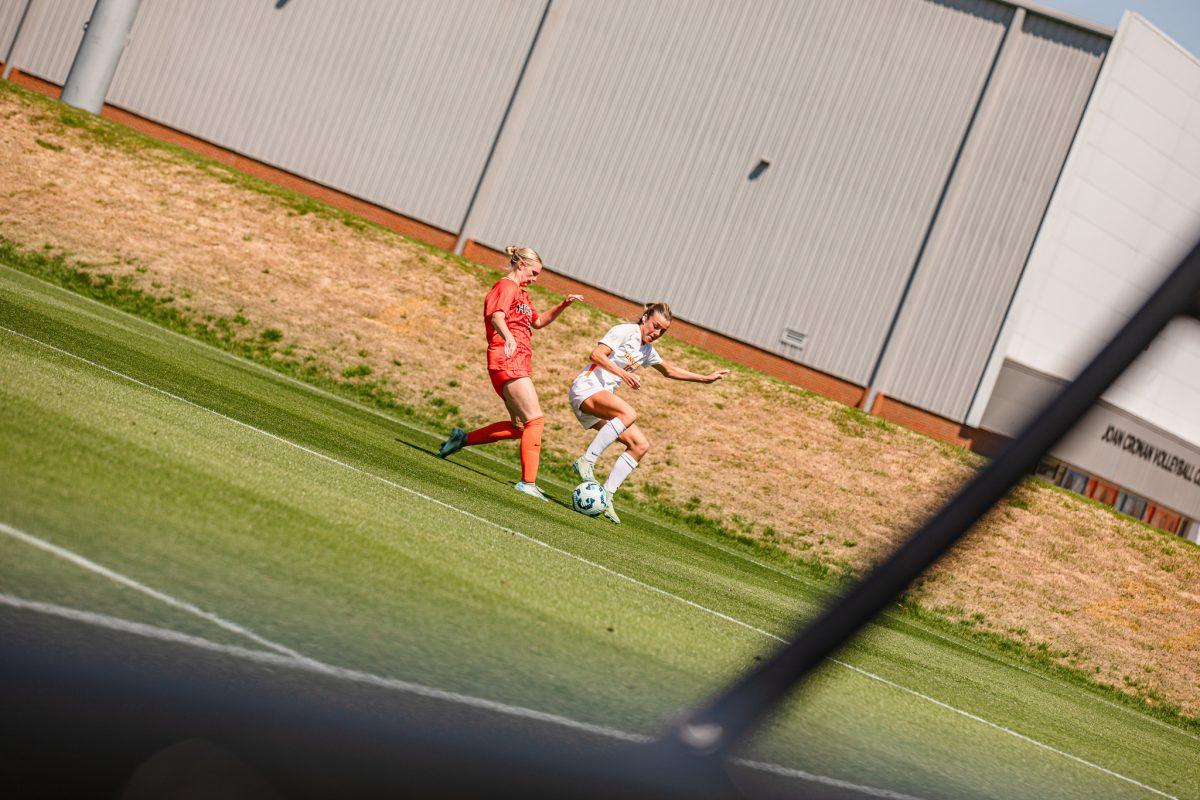 Kennedy Price (15) protects the ball from an opponent during a spring matchup against Virginia Tech at Regal Stadium. Sunday, April 13, 2025.