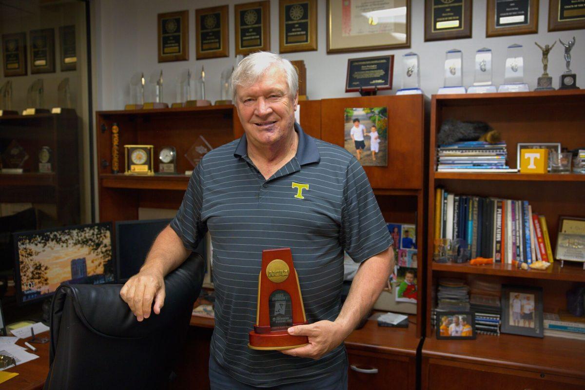 Tennessee dive coach Dave Parrington holds a 2024 NCAA Women's Swimming &amp; Diving trophy. Parrington announced his retirement on April 10, 2025 after 35 years. 
