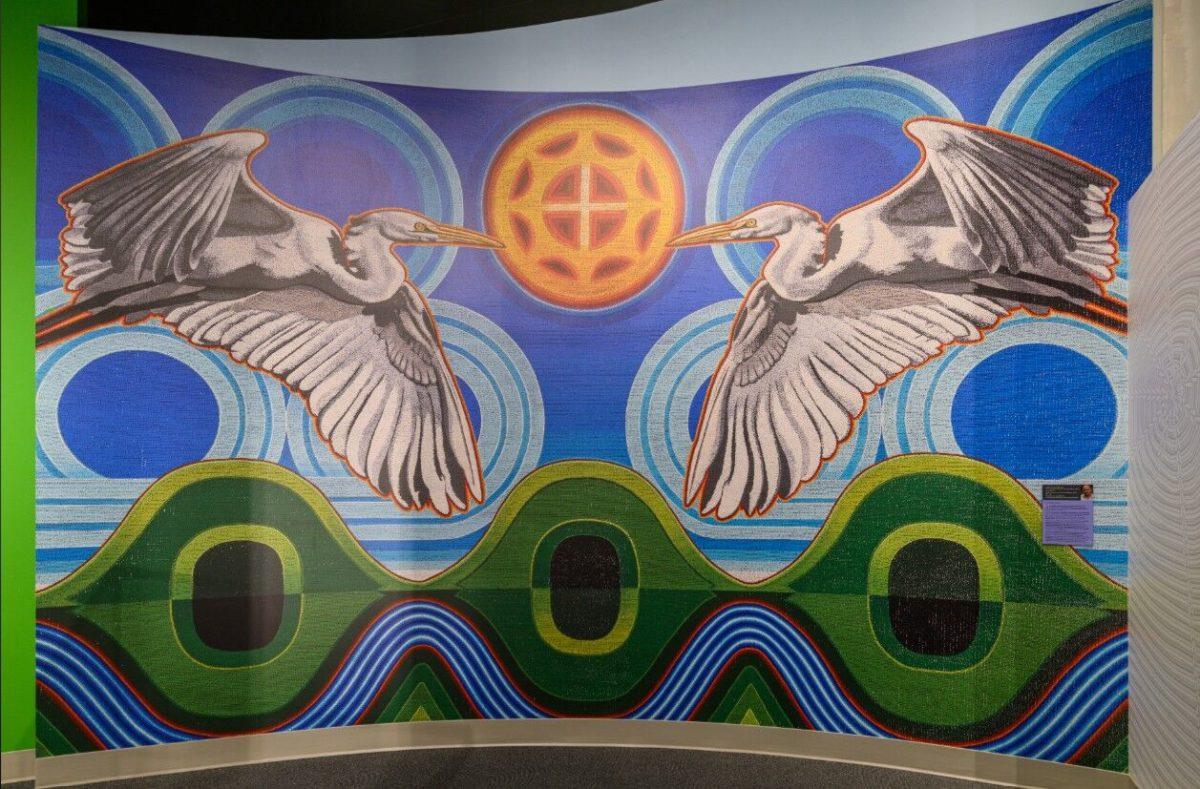 A mural by artist Starr Hardridge of the Muscogee (Creek) Nation. An artistic rendering of pre-Columbian mound sites in Knoxville, depicting the mounds with a river running underneath them. 