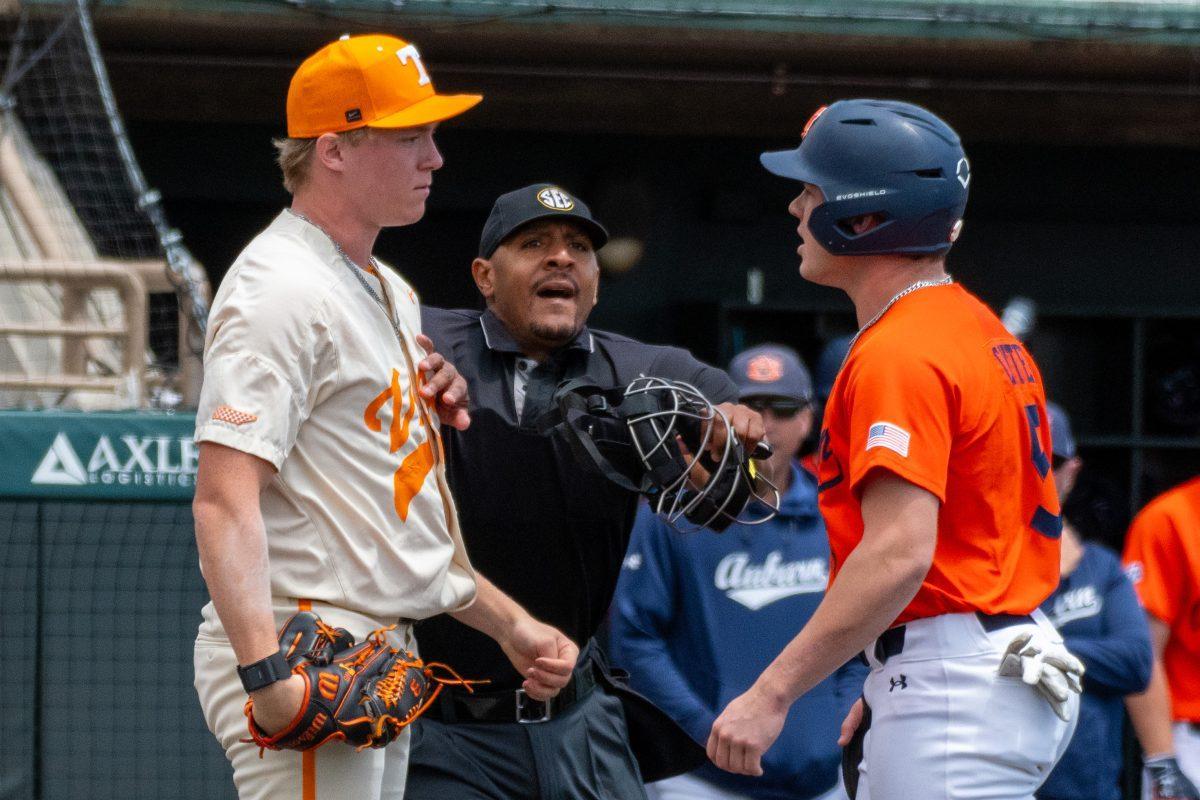 Tennessee's Liam Doyle (12) and Auburn's Bristol Carter (5) are separated by the home plate umpire after Doyle tags out Carter at home plate during a game at Lindsey Nelson Stadium. Sunday, May 4, 2025.