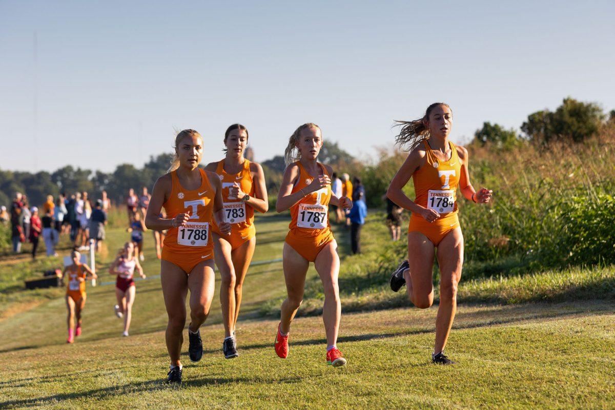 (from left) Jaci Sievers, Tula Fawbush, Summer Schuster and Andi-Marie Jones race run in a pack during the Tennessee Cross Country Invitational at Cherokee Farm. Friday, Aug. 29, 2025.
