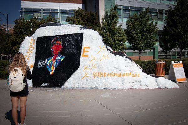 Freshman Leeba Curlin stands in front of Charlie Kurk mural at the Rock. Ansley Graves / The Daily Beacon