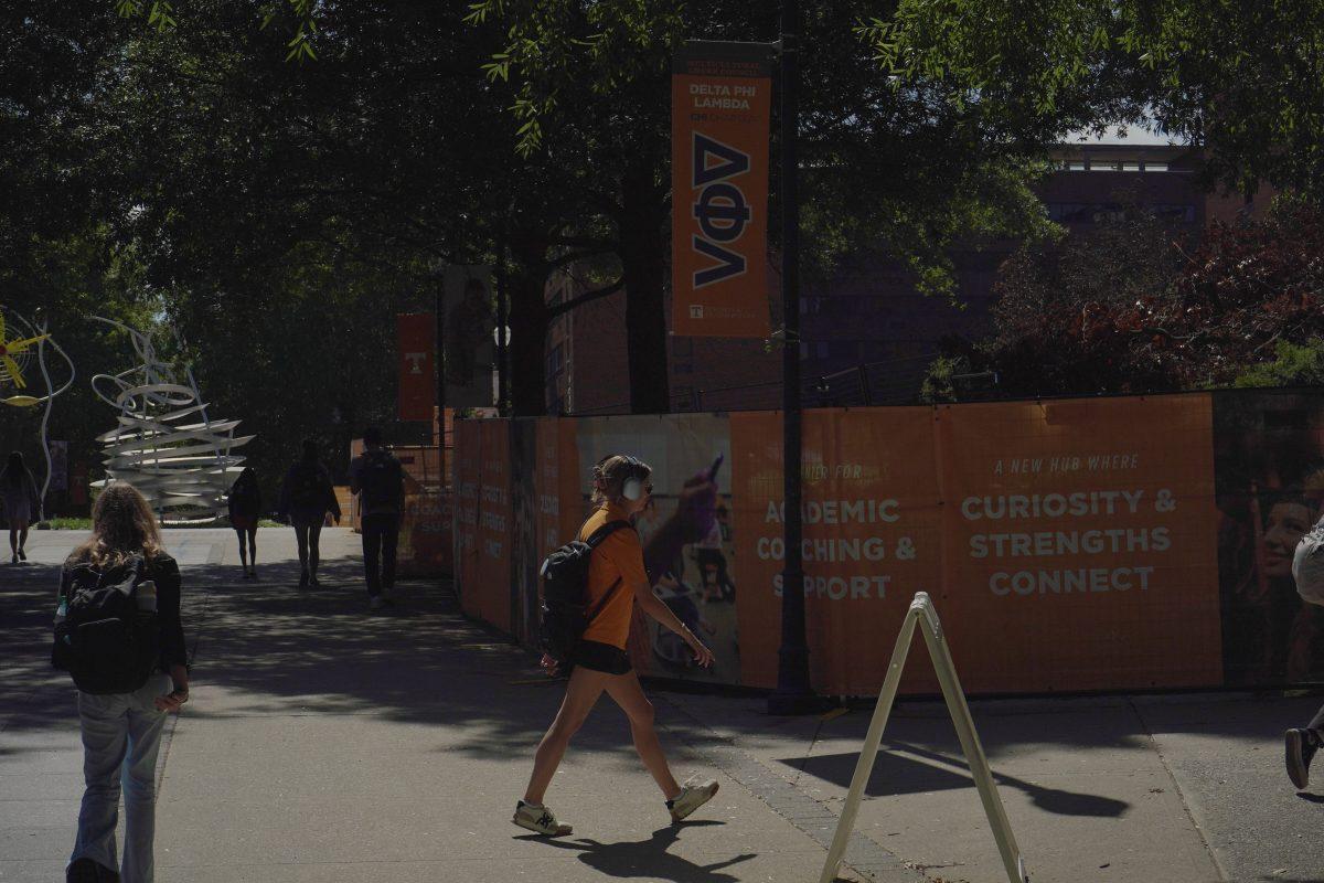 UT student listens to music on PED walkway. Friday, Sept. 12, 2025. 