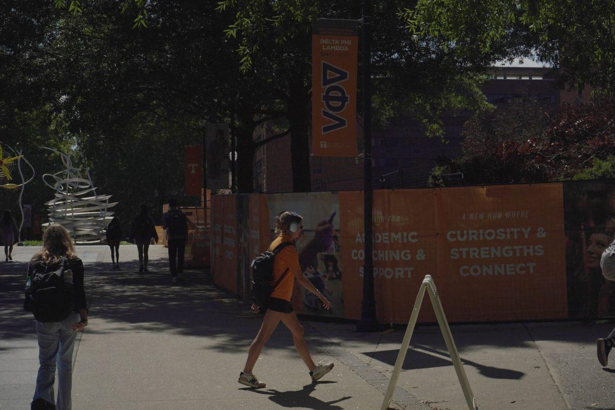 UT student listens to music on PED walkway. Friday, Sept. 12, 2025. 