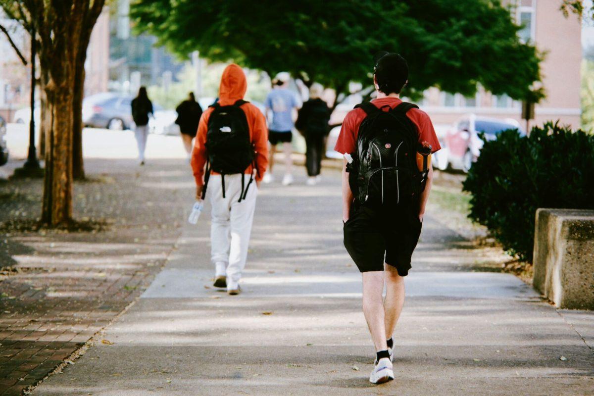 Male students walk alone on campus, Oct.21, 2025