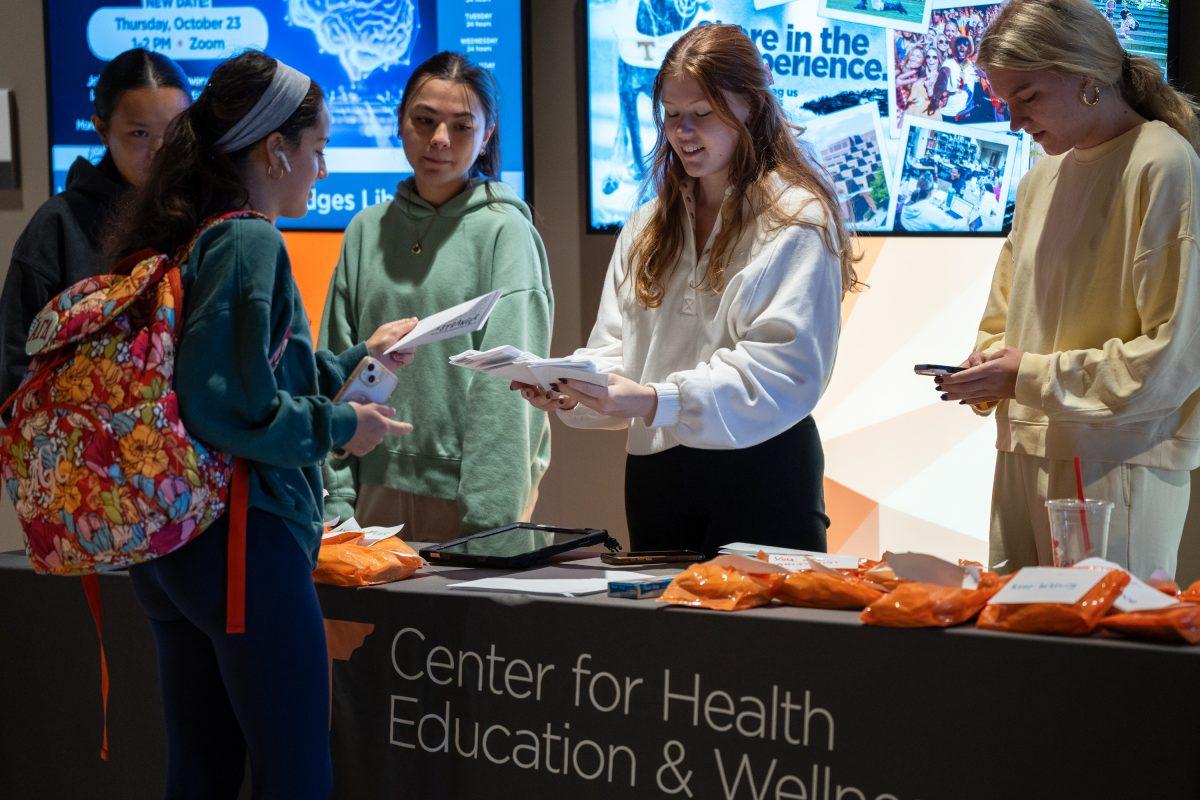 Peer Health Educators with the Center for Health Education and Wellness hand out letters to students during the Write a Letter, Spread Hope event in Hodges. Wednesday, Oct. 15, 2025