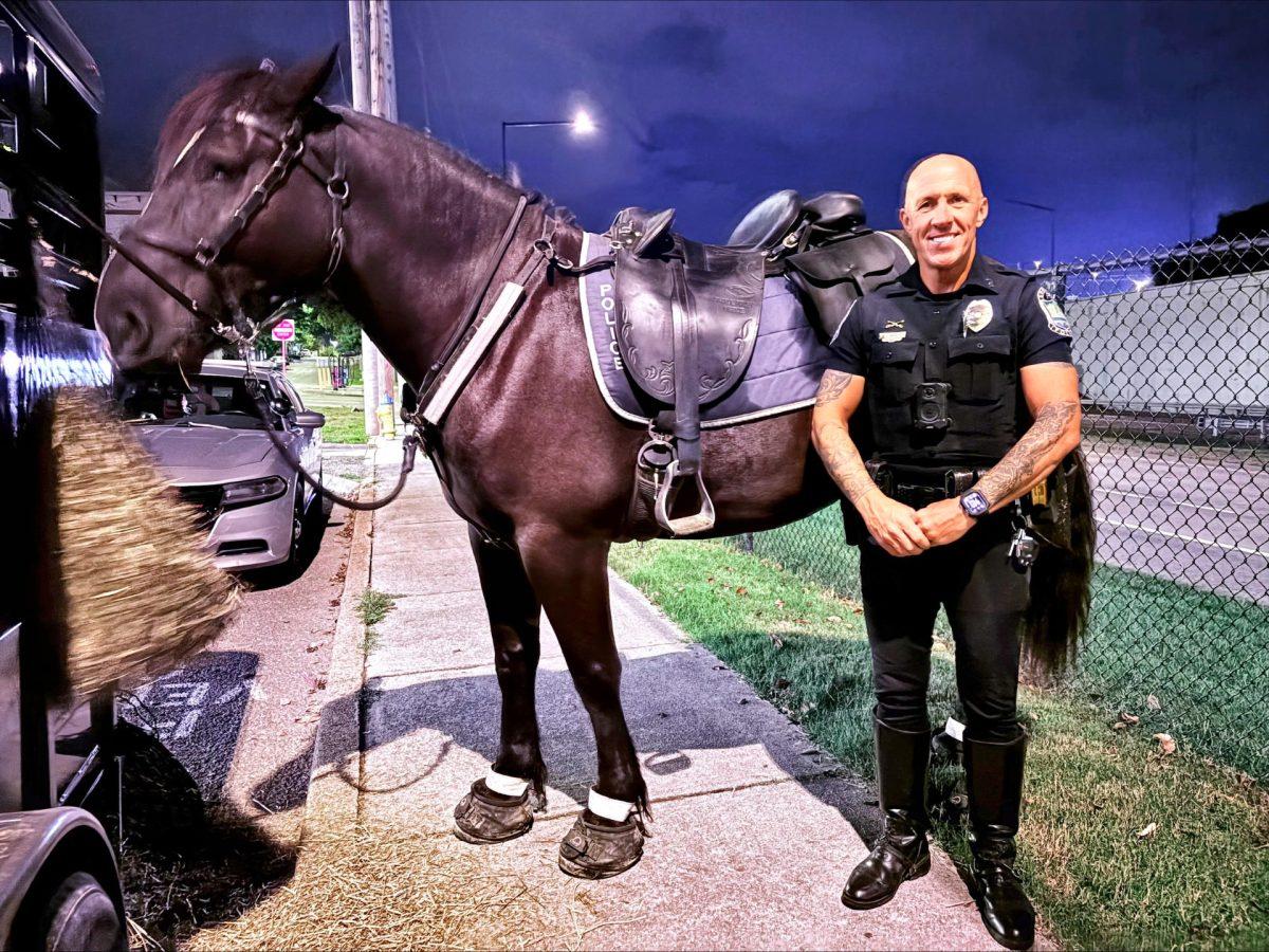 A member of Knoxville Police Department's mounted unit poses with his horse, Tuesday, Sept. 30.