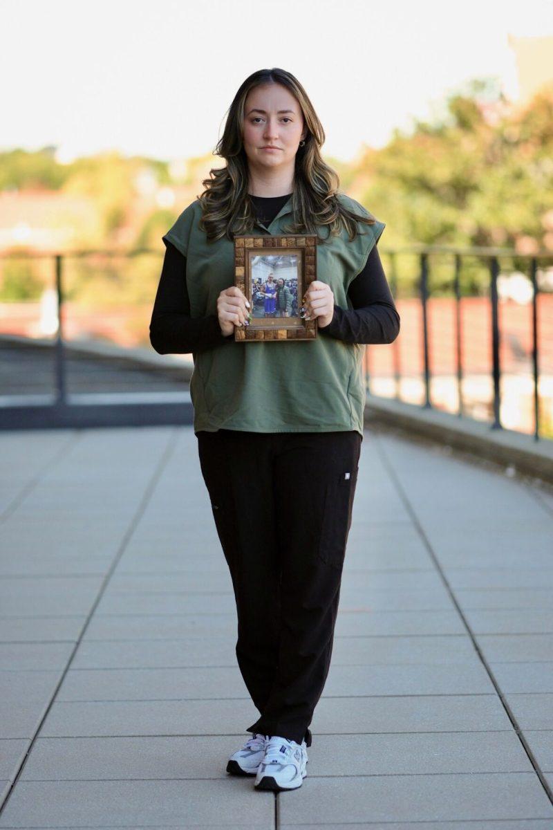 Klara Dolin stands proud with framed photo of her late brother, Conor. 