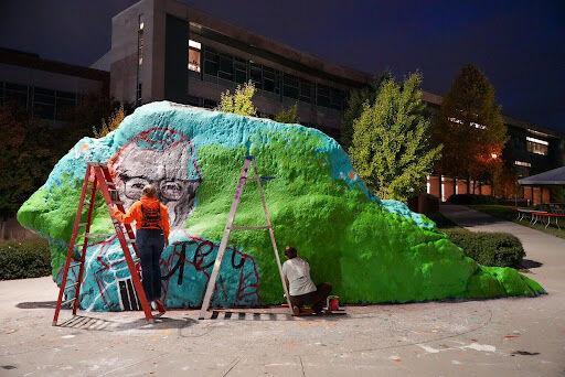 Chloe Peterson and Shay Furey painting a mural on Friday night for what would have been Senator Howard H. Baker Jr.’s 100th birthday. Sunday, Nov. 9, 2025.