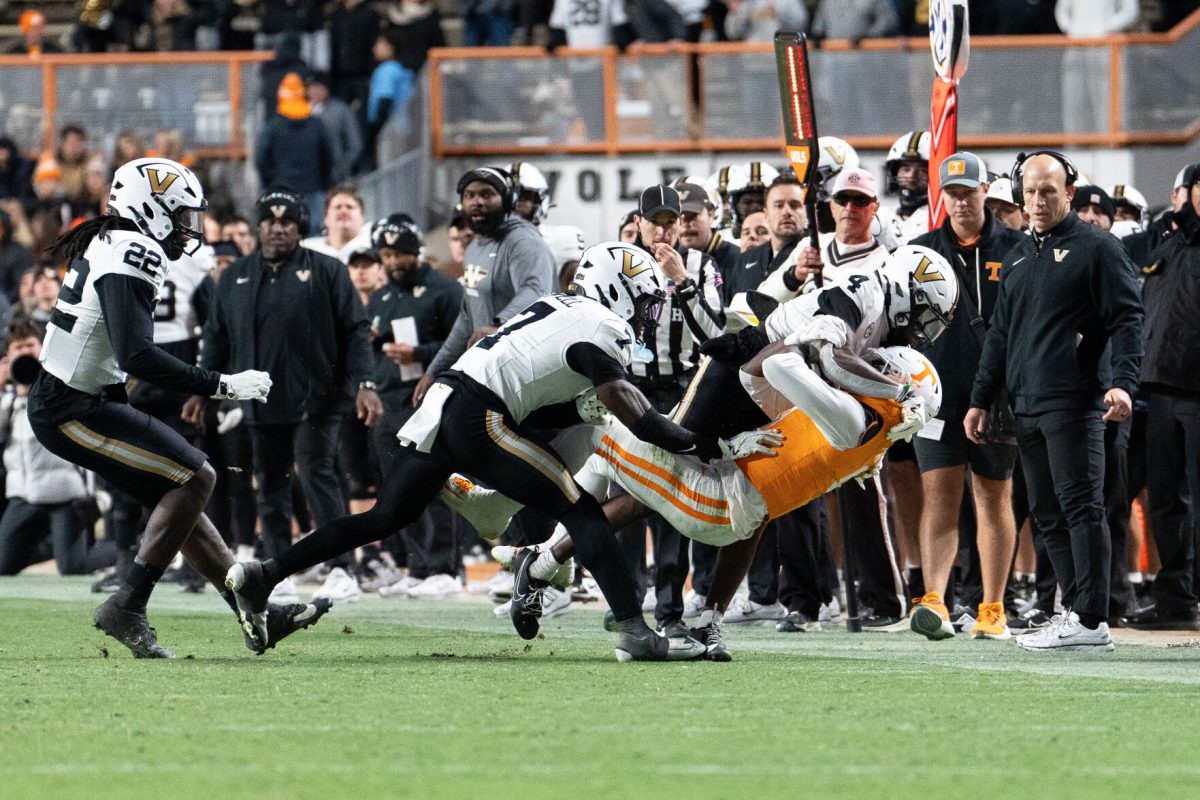 Tennessee's Mike Matthews (4) gets tackled by a couple of Vanderbilt players at Neyland Stadium. Saturday, Nov. 29, 2025.