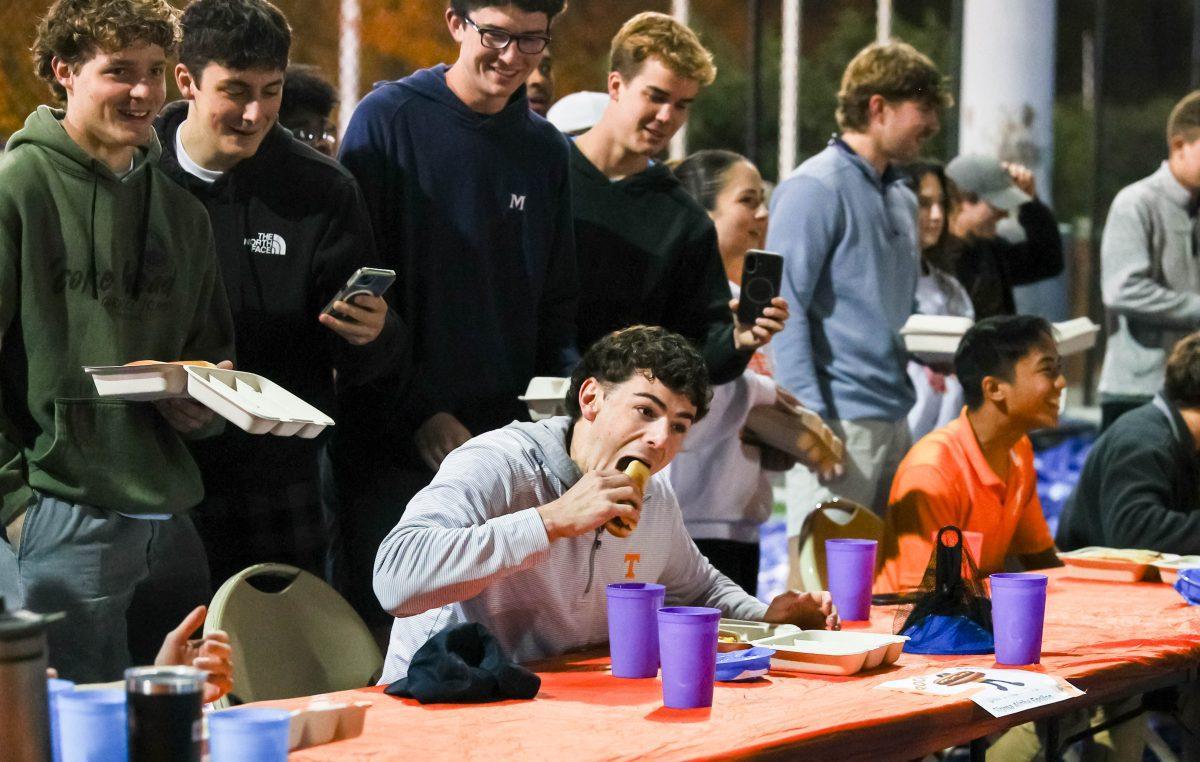A member of Sigma Alpha Epsilon competes in the Rocky Top Dog hot dog eating contest during Homecoming week on the TREC fields. Thursday, Nov. 13, 2025.