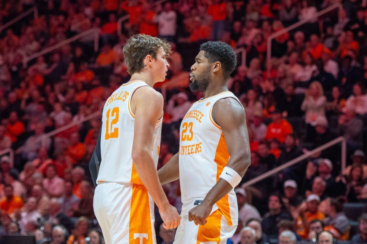 Cade Phillips (12) celebrates a play with Jaylen Carey (23) during a game against North Florida at Food City Center. Wednesday, Nov. 12, 2025.