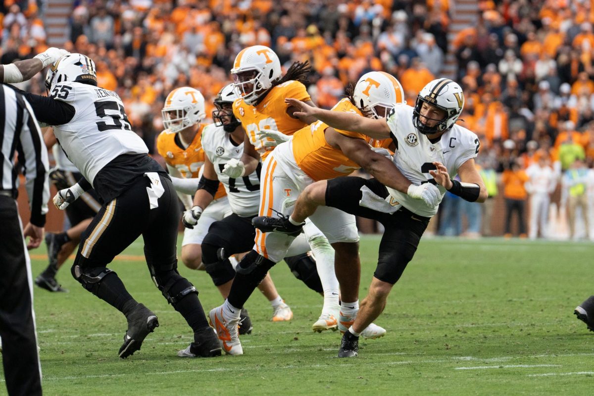 Bryson Eason (20) knocks Vanderbilt quarterback Diego Pavia (2) to the ground at Neyland Stadium. Saturday, Nov. 25, 2025.