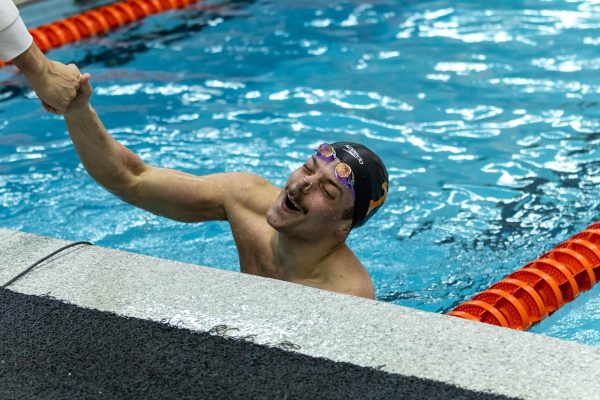 Nick Simons celebrates with a teammate after the Mens 50Y Freestyle at the Allan Jones Intercollegiate Aquatic Center. Friday, January 30th, 2026.