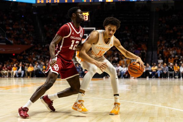 Nate Ament (10) protects the basketball from a defender during a game against Oklahoma at Food City Center. Feb. 18, 2026.