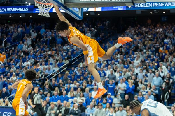 Bishop Boswell (3) hangs on the rim during a game against Kentucky at Rupp Arena. Saturday, Feb. 7, 2026.