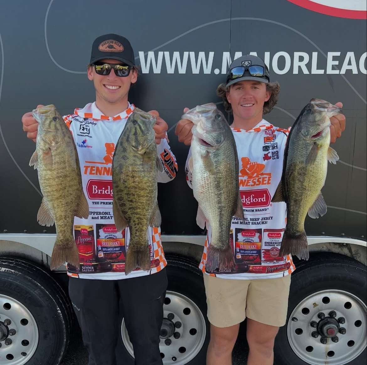 The University of Tennessee Bass Fishing Team hold up their catches. (Mason Thompson / The Daily Beacon)