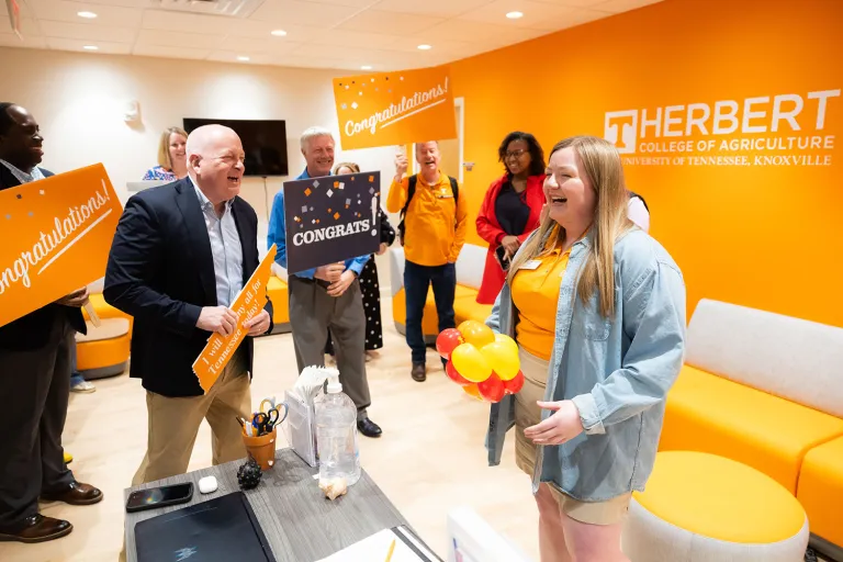Courtesy of the University of Tennessee Office of Communications and Marketing. Several UT administrators surprise Alice Grace Beavers with a 2026 Torchbearer award.
