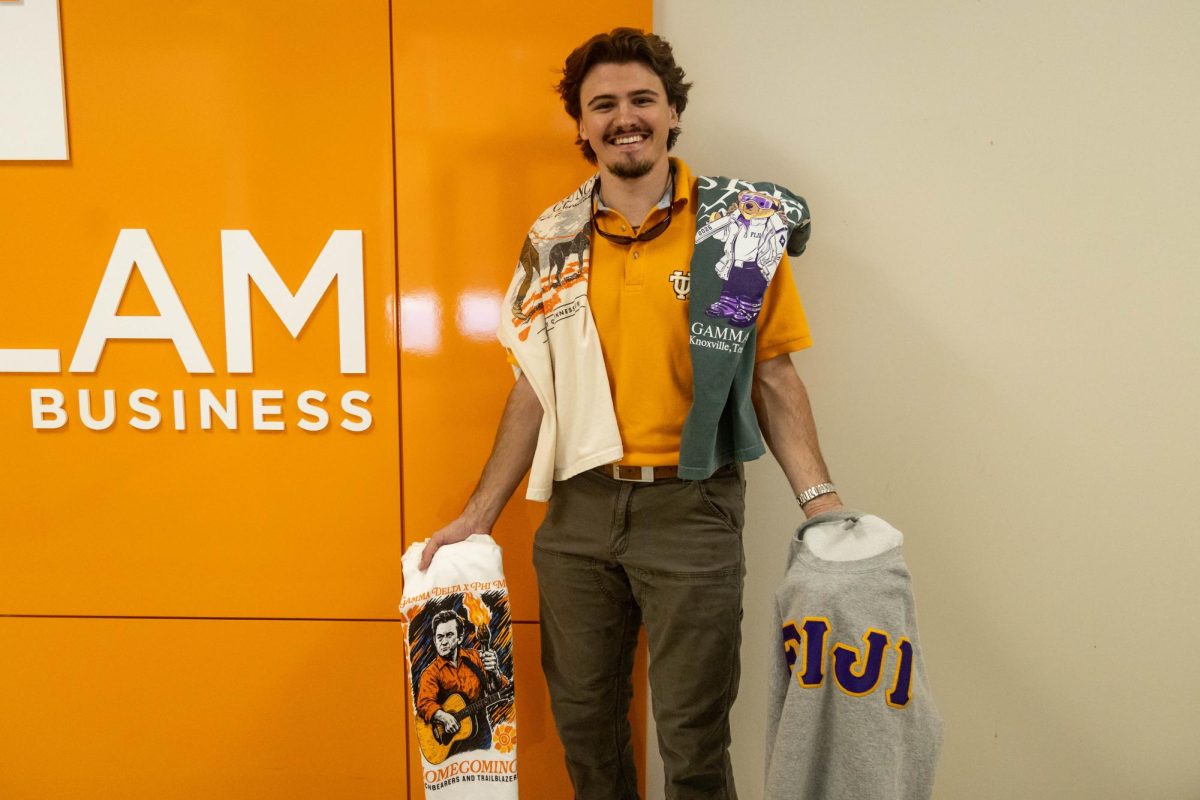Junior supply chain management major Colby Duncan with Fresh Prints merchandise in the Haslam School of Business on Friday, March 20. Duncan is the campus manager of Fresh Prints. 