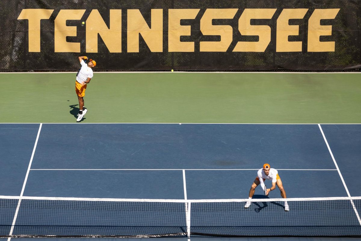 Jose Garcia serves the ball with Piore Seikanowicz looking on in a doubles match against Florida at Barksdale Stadium, Sunday, March 22, 2026. 