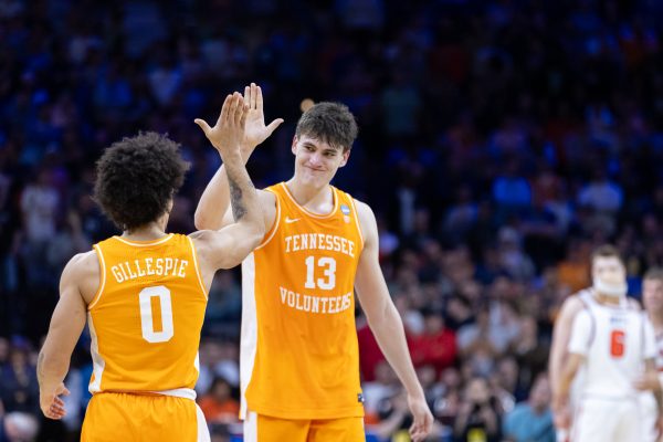 Ja'Kobi Gillespie (0) and JP Estrella (13) high-five after an NCAA tournament win over Virginia at Xfinity Mobile Arena. Sunday, March 22, 2026.