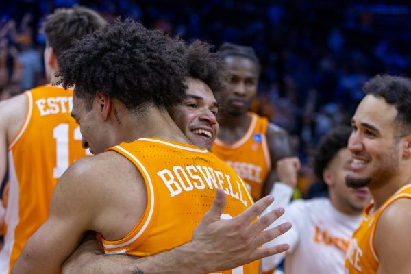 Bishop Boswell (3) and Ja'Kobi Gillespie (0) embrace after an NCAA tournament win over Virginia at Xfinity Mobile Arena. Sunday, March 22, 2026.