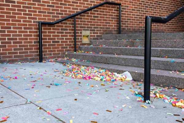 Some students choose to use confetti in their graduation photos, but often don't clean them up, leading to piles.