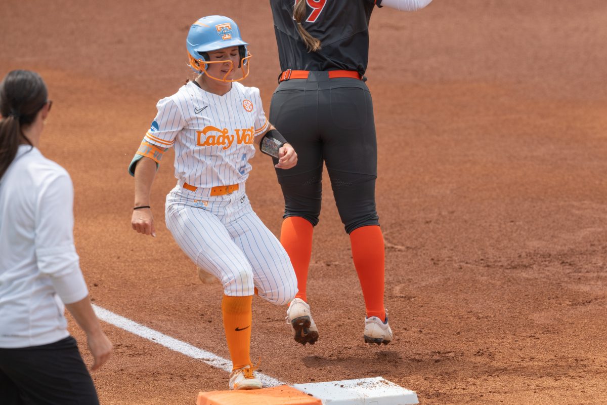 Sophia Knight (2) beats the throw to first for a single against Virginia in the NCAA Regionals at Sherri Parker Lee Stadium. Saturday, May 16, 2026.
