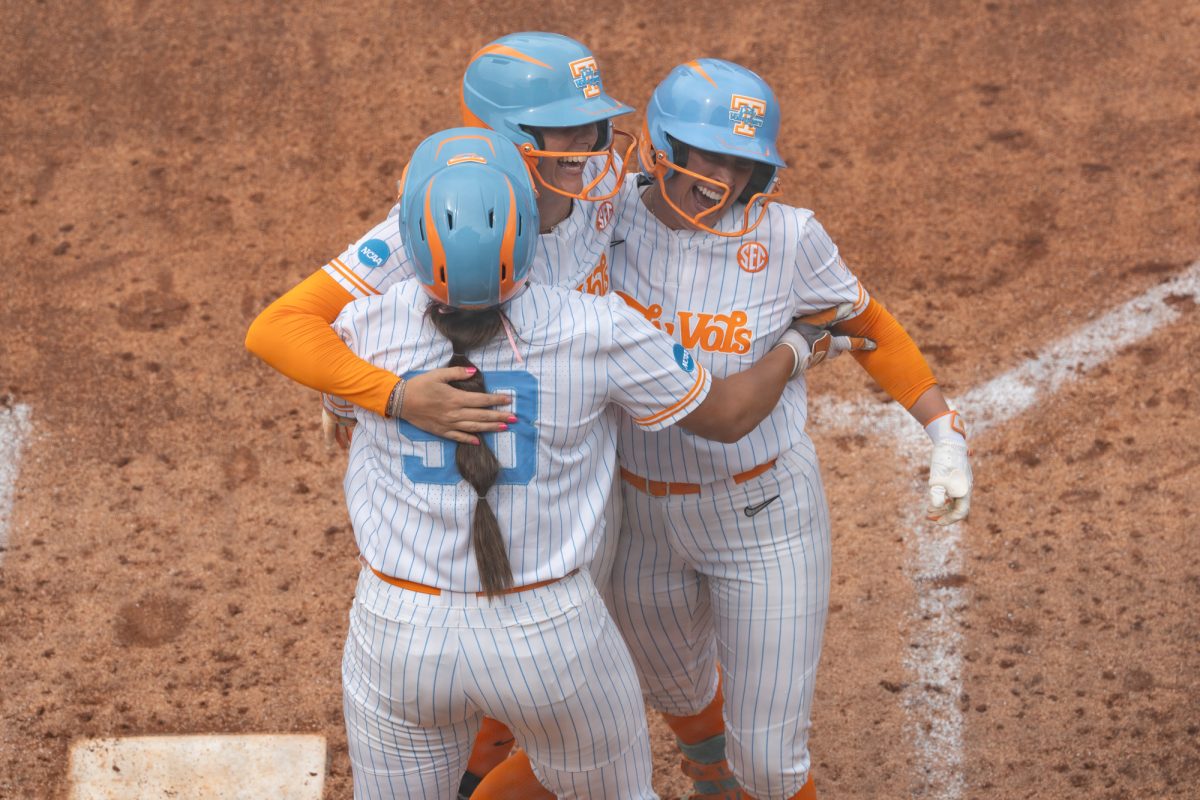 Emma Clarke (13) is greeted at home plate by teammates Makenzie Butt (98) and Gabby Leach (55) after hitting a home run against Virginia in the NCAA Regionals at Sherri Parker Lee Stadium. Saturday, May 16, 2026.